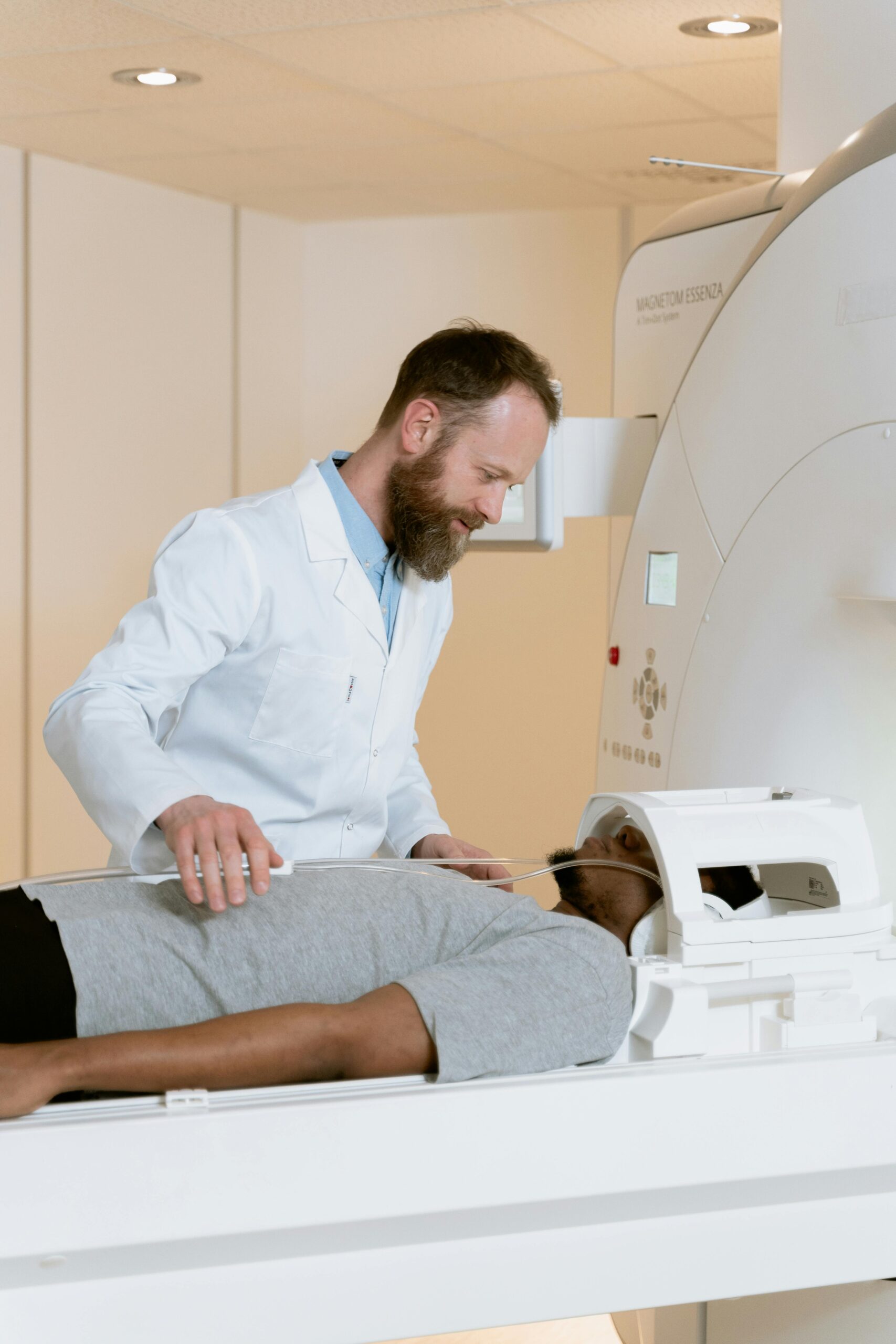 Doctor helping patient during MRI scan in a modern medical facility.